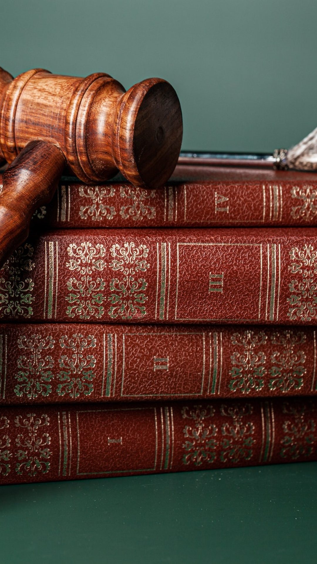 Law gavel and wedding rings on table